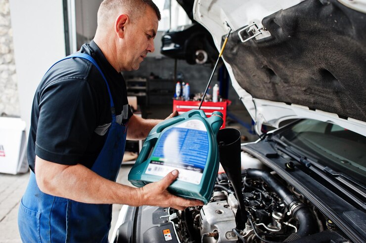 car-repair-maintenance-theme-mechanic-uniform-working-auto-service-pouring-new-motor-oil