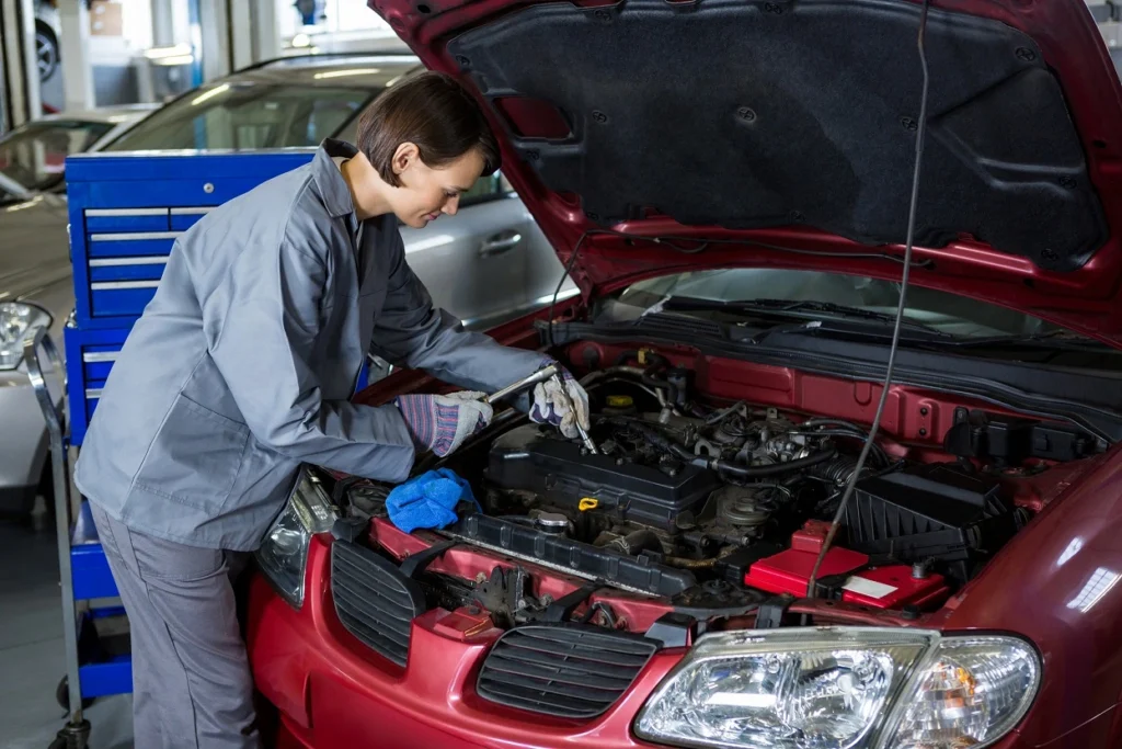 female-mechanic-checking-oil-level-car-engine