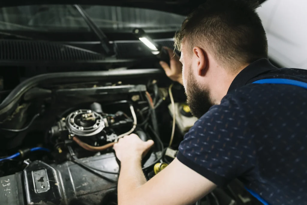 repairmen-inspecting-vehicle-engine-scaled