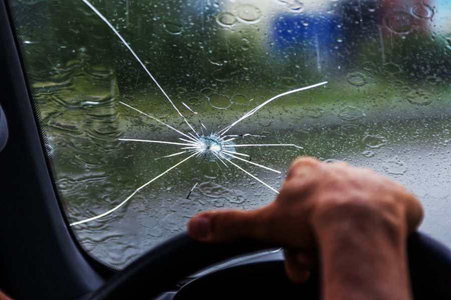 cracked-windshield-man-driving-in-rain