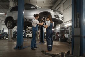 Mechanics repairing car in workshop